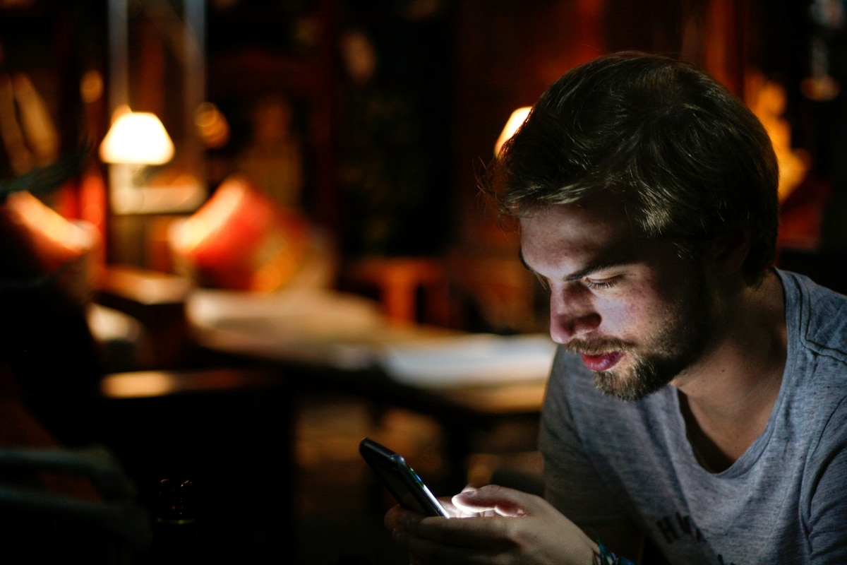 Man using his mobile phone discreetly in a bar